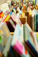 colourful children's books displayed in wooden boxes