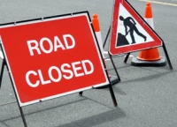 road works and road closure signs and orange and white cones