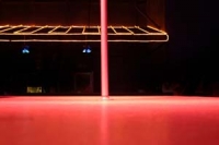 An empty pole on a stage in a club