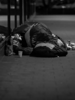 rough sleeper lying in sleeping bag