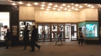 Shoppers at night walking in front of House of Fraser at Cavendish House