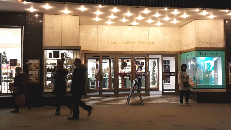 Shoppers at night walking in front of House of Fraser at Cavendish House