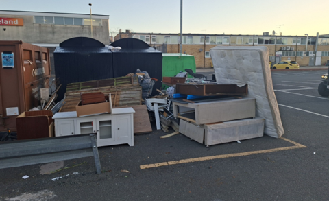 Photograph of fly-tipping at Edinburgh Place car park and recycling banks at Coronation Square, Hesters Way. 