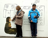 Pupils from Bettridge school stand in front of the advertising hoardings in Clarence Street which feature their images