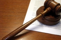 A wooden gavel on top of a document