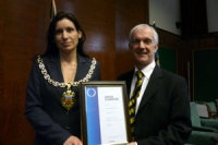 Councillor Wendy Flynn presents IiP award to chief executive Andrew North