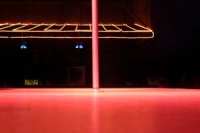 An empty pole on a stage in a club