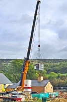 New cremator being lifted by a crane
