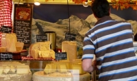 shopper at a french cheese stall - part of the continental market on Cheltenham's Promenade