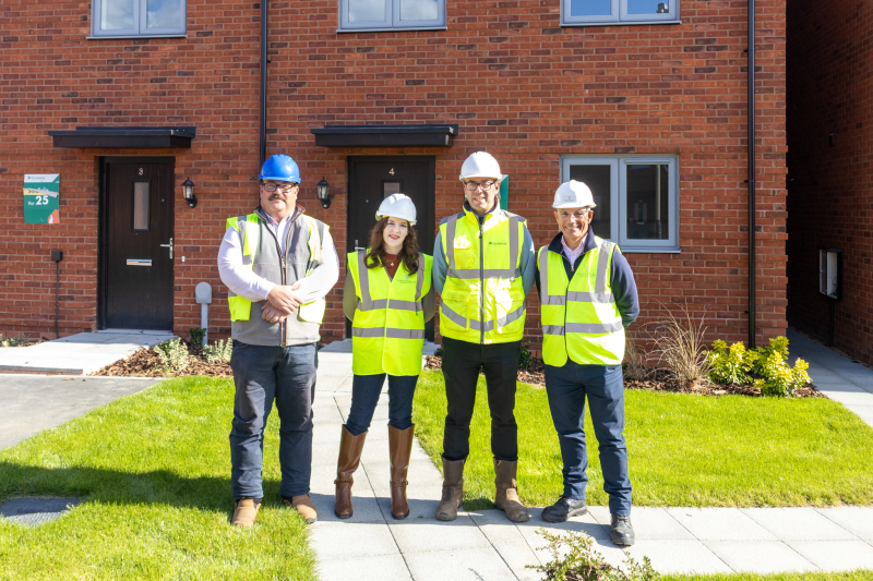 Picture of representatives from Cheltenham Borough Council, Persimmon Homes and Ward Williams in front of houses